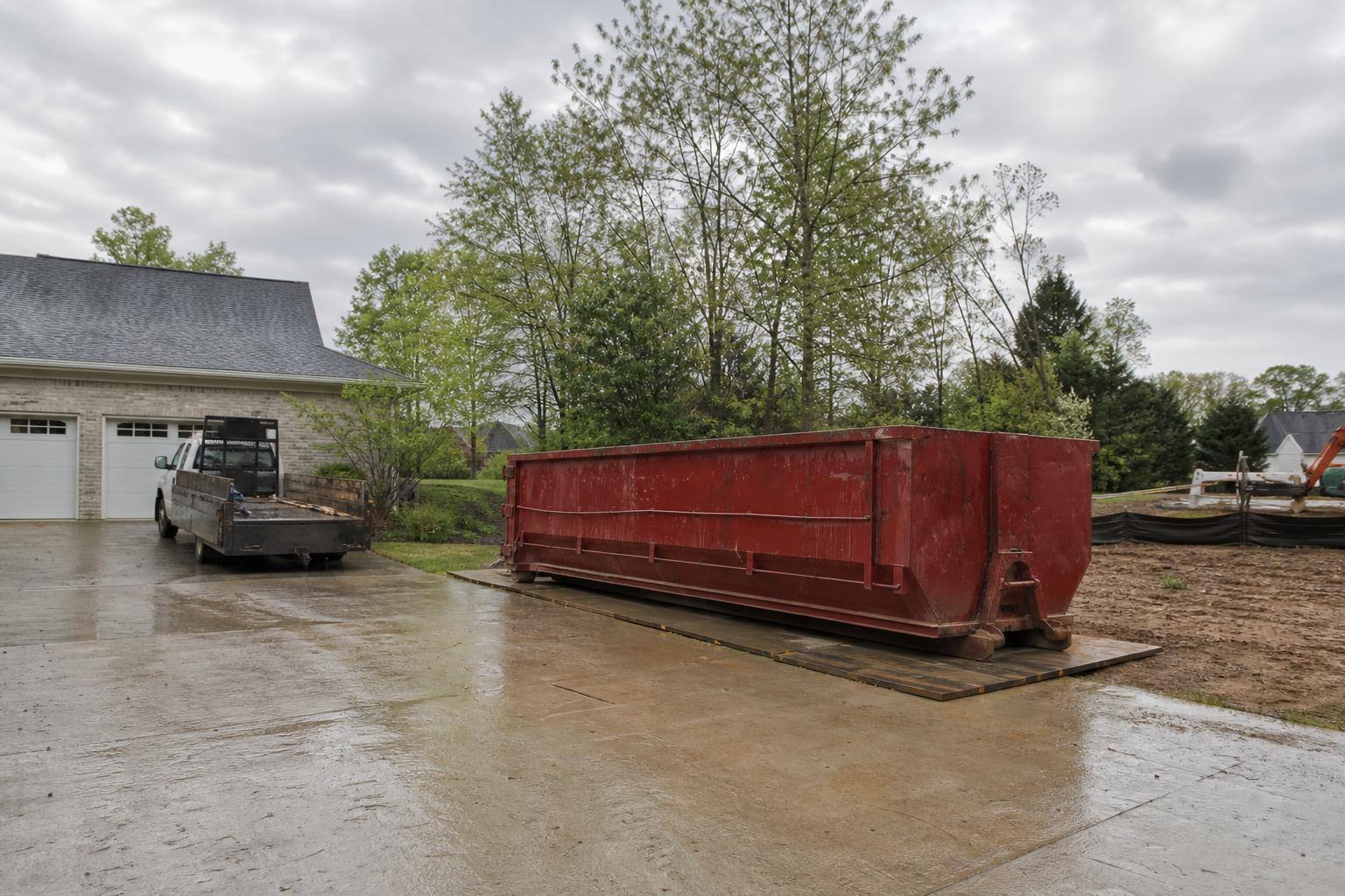 Clean roll-off dumpster at an organized job site in Mississippi